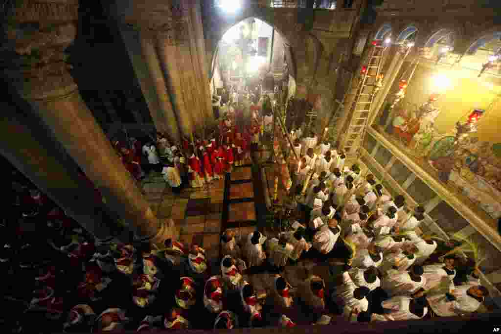Christian clergymen carry palm fronds during the Palm Sunday procession in the Church of the Holy Sepulcher, traditionally believed by many to be the site of the crucifixion, in Jerusalem&#39;s Old City.