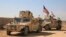 FILE - U.S. forces take up positions on the outskirts of the Syrian town of Manbij, a flashpoint between Turkish troops and allied Syrian and U.S.-backed Kurdish fighters, March 7, 2017.