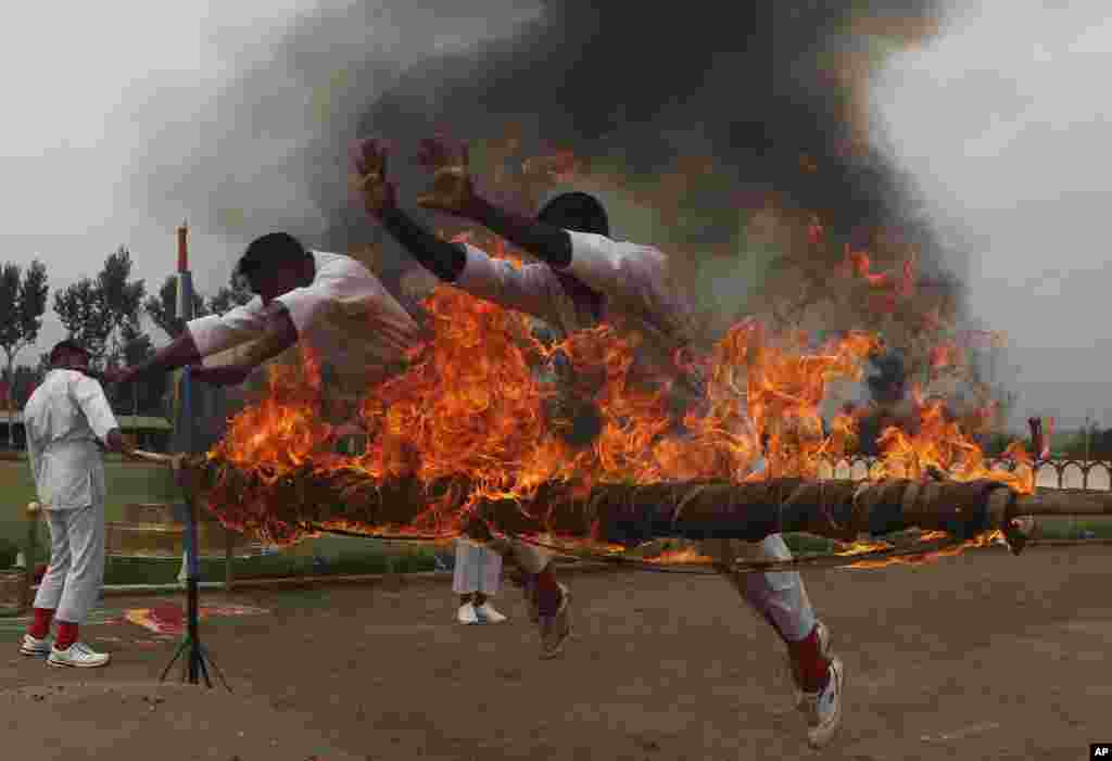 Soldiers of the Indian Central Reserve Police Force (CRPF) display their skills during a passing out parade on the outskirts of Srinagar.