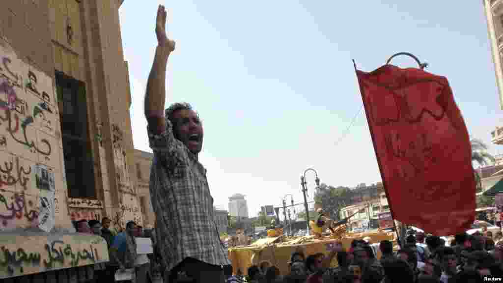 Members of the April 6 Youth Movement and activists shout slogans as they protest against former president Hosni Mubarak's release from prison, in front of the courthouse and the Attorney General's office in downtown Cairo August 23, 2013. Mubarak was flo