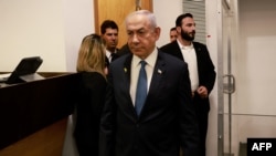 raeli Prime Minister Benjamin Netanyahu enters the district court in Tel Aviv at the start of his hearing on corruption charges on December 10, 2024.