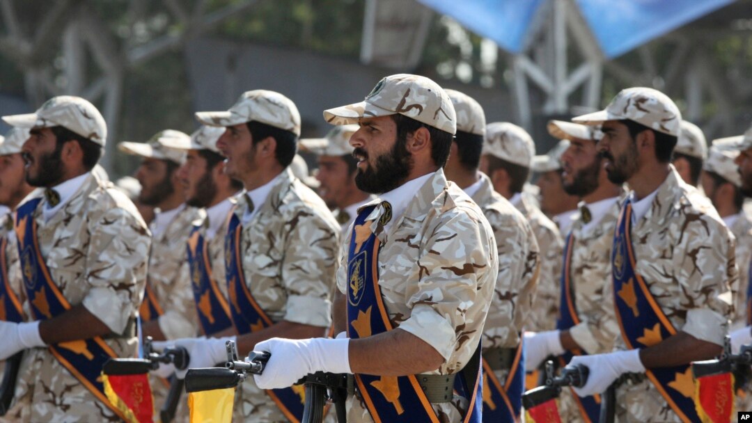 FILE - Members of Iran's Revolutionary Guard in front of the mausoleum of the late Iranian revolutionary founder Ayatollah Khomeini, outside Tehran, Iran, Sept. 22, 2011.
