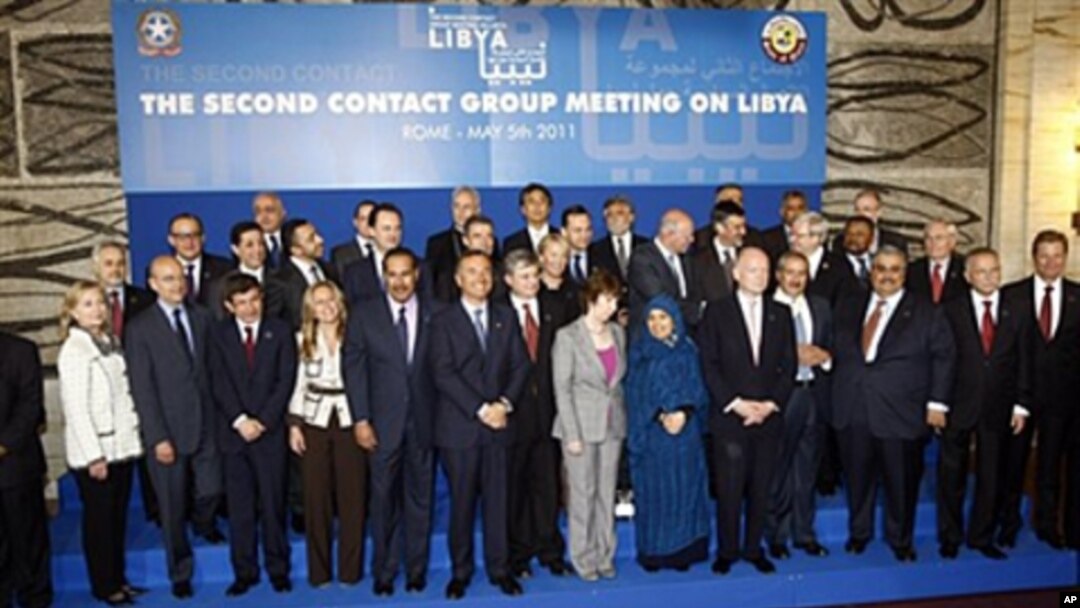 Italian Foreign Minister Franco Frattini, center, poses with the other delegates during a group photo following a meeting on how to support rebels fighting the Libyan leader Moammar Gadhafi, at Rome's Foreign Ministry, May 5, 2011