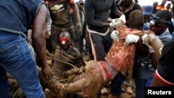 FILE: A rescued artisanal miner is carried from a pit as retrieval efforts proceed for trapped illegal gold miners in Kadoma, Zimbabwe, February 16, 2019. 