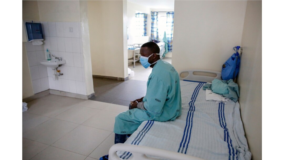 A patient sits in a ward for those who have tested positive for the new coronavirus, at the infectious disease unit of Kenyatta National Hospital, in Nairobi, Kenya, May 1, 2020.