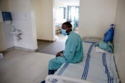 A patient sits in a ward for those who have tested positive for the new coronavirus, at the infectious disease unit of Kenyatta National Hospital, in Nairobi, Kenya, May 1, 2020.