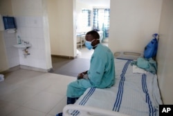 A patient sits in a ward for those who have tested positive for the new coronavirus, at the infectious disease unit of Kenyatta National Hospital, in Nairobi, Kenya, May 1, 2020.
