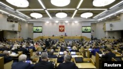 FILE - Duma members listen to Russian Prime Minister Dmitry Medvedev who delivers a speech during a session at the State Duma, the lower house of parliament, in Moscow.