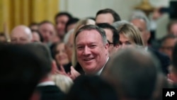 Secretary of State Mike Pompeo smiles as President Donald Trump speaks about him during an event with Israeli Prime Minister Benjamin Netanyahu in the East Room of the White House in Washington, Jan. 28, 2020.