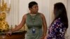 FILE - White House Social Secretary Deesha Dyer, left, talks with a colleague during the annual Mother’s Day Tea hosted by first lady Michelle Obama and Jill Biden to honor military-connected mothers at the White House in Washington, May 8, 2015. 