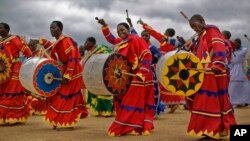 Members of the International Apostolic Ejuwel Jekenisheni Church dance, sing, pray, and play drums during a morning service at the open-air church on the outskirts of Harare, Zimbabwe Sunday, Nov. 19, 2017. (AP)
