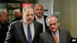 FILE- Harvey Weinstein, left, arrives at New York Supreme Court with his attorney Benjamin Brafman in New York, Dec. 20, 2018. Brafman filed court papers on Thursday, Jan. 17, 2019, asking to withdraw as Weinstein's lawyer.