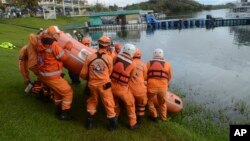 A rescue crew prepares to search for survivors in the reservoir in Guatape, Colombia, June 26, 2017, where a tourist boat packed with passengers for the holiday weekend sank.