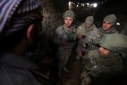 Turkish soldiers drink tea in the Syrian province of Idlib, Feb. 10, 2020. Turkey said it hit back at Syrian government forces on Monday, after "intense" Syrian shelling killed five of its soldiers and wounded five others.
