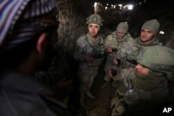 Turkish soldiers drink tea in the Syrian province of Idlib, Feb. 10, 2020. Turkey said it hit back at Syrian government forces on Monday, after "intense" Syrian shelling killed five of its soldiers and wounded five others.