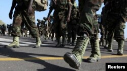 FILE - Members of the Eastern Africa Standby Brigade from Uganda march to board a French tactical aircraft C160 Transall at the French Air Base 188 in Djibouti, Dec. 5, 2009. 