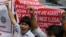 Vietnamese expatriates shout slogans in front of the Chinese Consulate at the financial district of Makati city to protest the recent moves by China to construct an oil rig near the Vietnamese-claimed Paracels, May 16, 2014. 