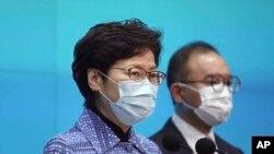 Chief Executive Carrie Lam, left, with Secretary for Constitutional and Mainland Affairs Erick Tsang Kwok-wai, speaks during a news conference in Hong Kong, April 22, 2020 to announce the new appointed principal officials.