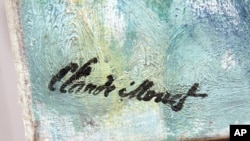 FILE - In this Jan. 19, 2011, photo, the signature of French impressionist painter Claude Monet is seen on the corner of his vast water lilies painting at the Cleveland Museum of Art in Cleveland.