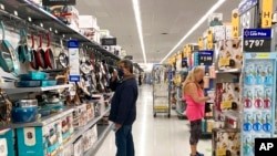 FILE - Consumers shop at a Walmart store in Vernon Hills, Ill., May 23, 2021. 