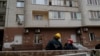 Ukrainian rescuers inspect damage to a residential building following a drone attack in Kyiv on Jan. 10, 2025, amid the Russian invasion of Ukraine. 