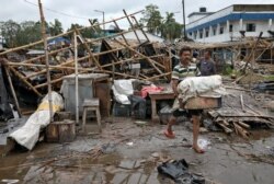 A man salvages his belongings from the rubble of a damaged shop in South 24 Parganas district, India, on May 21, 2020, after Cyclone Amphan made landfall.