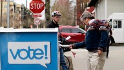 Voters drop off ballots in the Washington State primary, Tuesday, March 10, 2020 in Seattle. Washington is a vote by mail state. (AP Photo/John Froschauer)