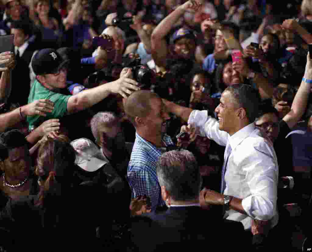 President Barack Obama greets supporters at a campaign event in Desert Pines High School in Las Vegas, Nevada, Sept. 30, 2012. 