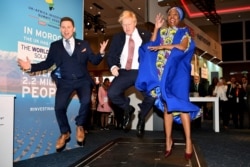 British Prime Minister Boris Johnson visits the Pavegen stand, a company that converts footsteps into energy, at the Innovation Zone during the UK-Africa Investment Summit in London.