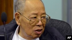 In this photo released by the Extraordinary Chambers in the Courts of Cambodia, Ieng Sary, the Khmer Rouge's former foreign minister, listens to testimony being given during his trial at the U.N.-backed war crimes tribunal in Phnom Penh, file photo. 