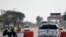 FILE - Police officers stand at a checkpoint after a shooting at Naval Air Station Corpus Christi, Texas, May 21, 2020. 