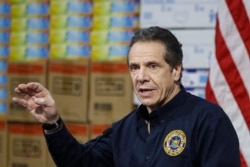 FILE - New York state Governor Andrew Cuomo speaks during a news conference against a backdrop of medical supplies at the Jacob Javits Center that will house a temporary hospital in response to the COVID-19 outbreak, March 24, 2020, in New York City.