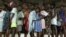 FILE - Liberian children queue for their measles vaccinations in an International Rescue Committee clinic in Monrovia, August 26, 2003.
