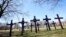 FILE - In this April 19, 2018 file photo, crosses representing victims of gun violence stand outside Collins Academy High School in Chicago's North Lawndale neighborhood. 