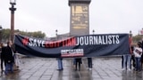 FILE — RSF activists hold a banner at the obelisk of the Place de la Concorde in Paris, on October 24, 2017 calling on Egyptian Presiden Abdel-Fattah el-Sissi to respect journalists rights. 