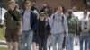 FILE - Students walk across campus at the University of Vermont in Burlington, Vt. Federal statistics show 43 million people in the United States owe federal student loan debt.