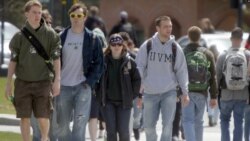 FILE - Students walk across campus at the University of Vermont in Burlington, Vt. Federal statistics show 43 million people in the United States owe federal student loan debt.