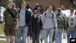 FILE - Students walk across campus at the University of Vermont in Burlington, Vt. Federal statistics show 43 million people in the United States owe federal student loan debt.