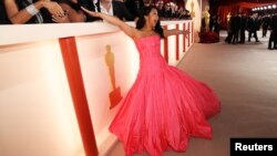 Stephanie Hsu poses on the champagne-colored red carpet during the Oscars arrivals at the 95th Academy Awards in Hollywood, Los Angeles, California, March 12, 2023.