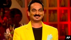 FILE - In this March 29, 2015 photo, Indian designer Wendell Rodricks walks the runway at the grand finale of Amazon India Fashion Week in New Delhi, India. 