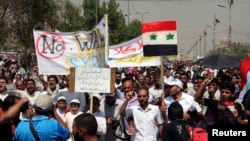 Supporters of religious and political leader Muqtada al-Sadr demonstrate against the possibility of a U.S. military strike against the Syrian government, in Baghdad's Sadr City August 30, 2013.