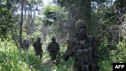 FILE - Soldiers of the Uganda People's Defence Force (UPDF) patrol in the jungle in the Central African Republic as they look for Lord's Resistance Army (LRA) fighters.