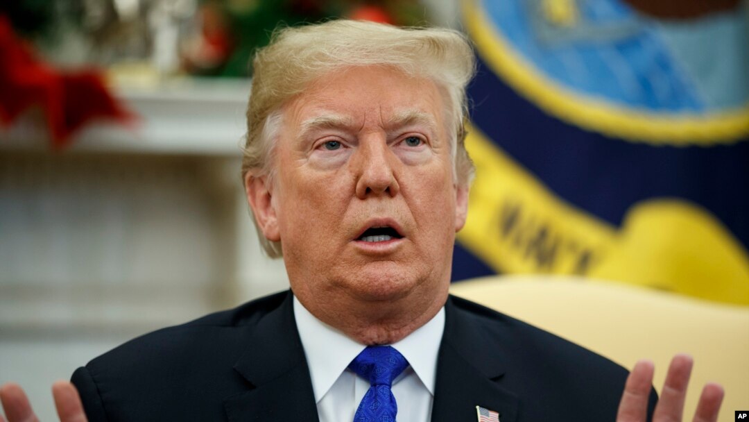 In this Dec. 11, 2018 photo, President Donald Trump speaks during a meets with Democratic leaders the Oval Office in Washington. 