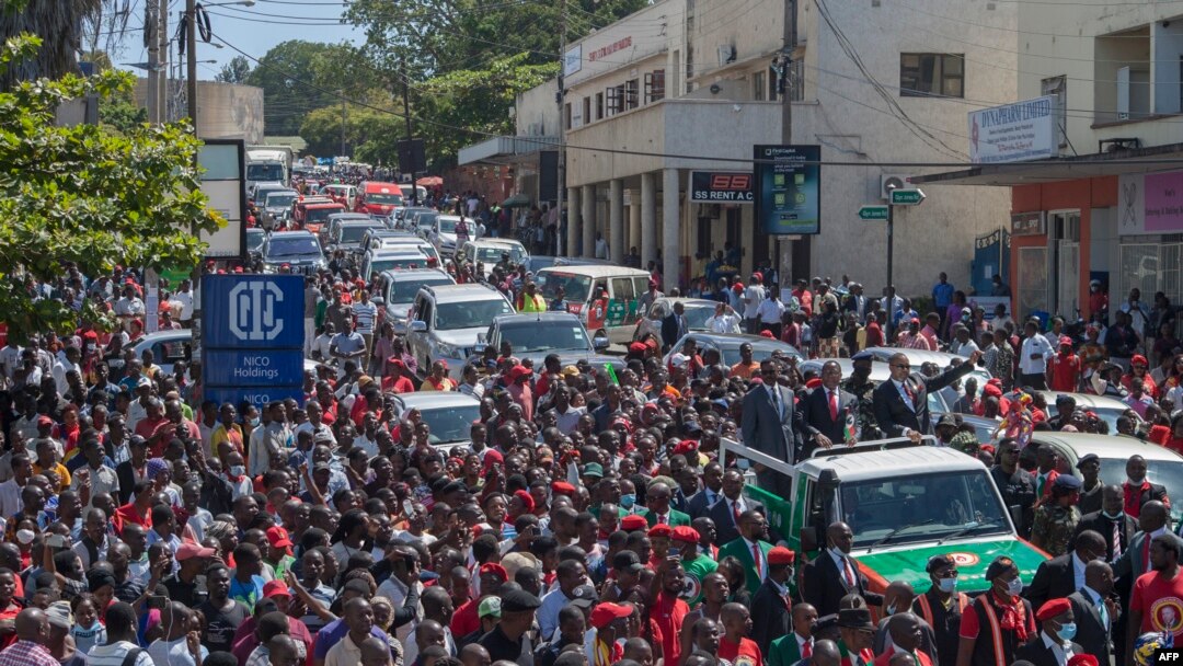 Lazarus Chakwera (C on pick-up truck), the president for Malawi’s main opposition Party, the Malawi Congress Party, and his running mate, Saulos Klaus Chilima (R), surrounded by supporters, leave the Mount Soche Hotel in Blantyre, May 6, 2020.