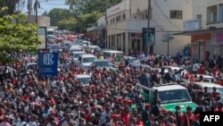 Lazarus Chakwera (C on pick-up truck), the president for Malawi’s main opposition Party, the Malawi Congress Party, and his running mate, Saulos Klaus Chilima (R), surrounded by supporters, leave the Mount Soche Hotel in Blantyre, May 6, 2020.