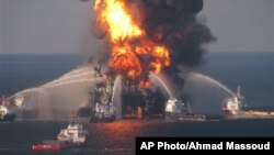 FILE - In this April 21, 2010 file image provided by the U.S. Coast Guard, fire boat response crews battle the blazing remnants of the off shore oil rig Deepwater Horizon.