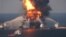 FILE - In this April 21, 2010 file image provided by the U.S. Coast Guard, fire boat response crews battle the blazing remnants of the off shore oil rig Deepwater Horizon.
