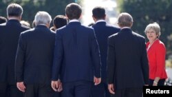 FILE - Britain's Prime Minister Theresa May arrives for a family photo during the European Union leaders informal summit in Salzburg, Austria, Sept. 20, 2018.