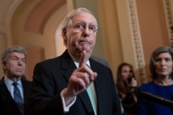 Senate Majority Leader Mitch McConnell, joined by Sen. Roy Blunt, left, and Sen. Joni Ernst, right, dismisses the impeachment process against President Donald Trump saying, "I'm not an impartial juror. This is a political process," Dec. 17, 2019.