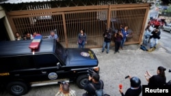 A vehicle of Directorate General of Military Counterintelligence leaves the building where Juan Marquez, uncle of Venezuela's opposition leader Juan Guaido, lives, in Caracas, Venezuela, Feb. 20, 2020. 